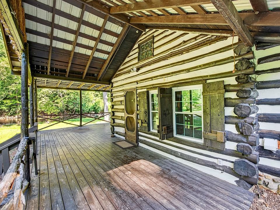 Covered porch beside the cabin's log walls